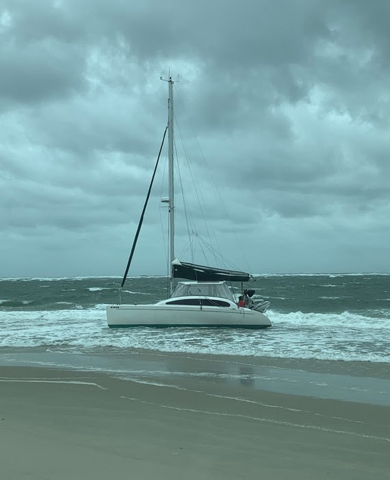 VIDEO: Coast Guard rescues four from sailboat now grounded on Oregon Inlet’s north shore